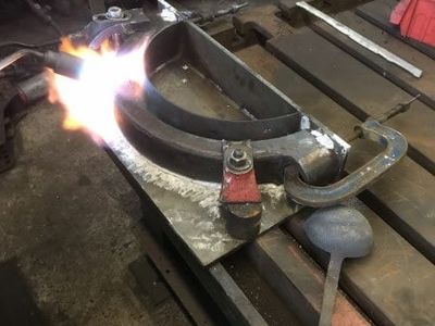 The tinned half is then put into the chill and sealed with fire cement. Here it is being reheated ready to pour the molten white metal into the gap.