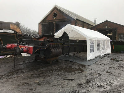 The frames are wheeled outside and a tent put up over one end ready for shot blasting. The tent not only keeps the frames dry where they are being blasted but also keeps the shot contained making it much easier to clean up at the end of the day.