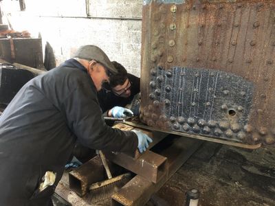 Kerry and Jack dig out all the rust and scale from the foundation ring of the boiler