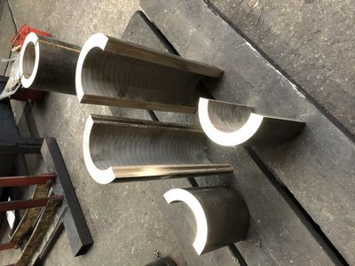 The bronze material for the rocker bearings and brake shaft have been sliced in half and machined ready for sweating together to machine as a single piece before parting them at the end.