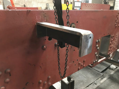 One of the tank brackets in place on the side of the frames.