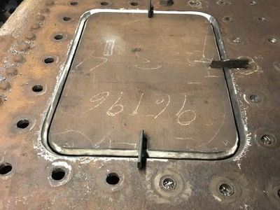 A section of the top wrapper plate has also been cut out to remove wasted plate and here the new patch has been made and curved to neatly fit ready for welding.
