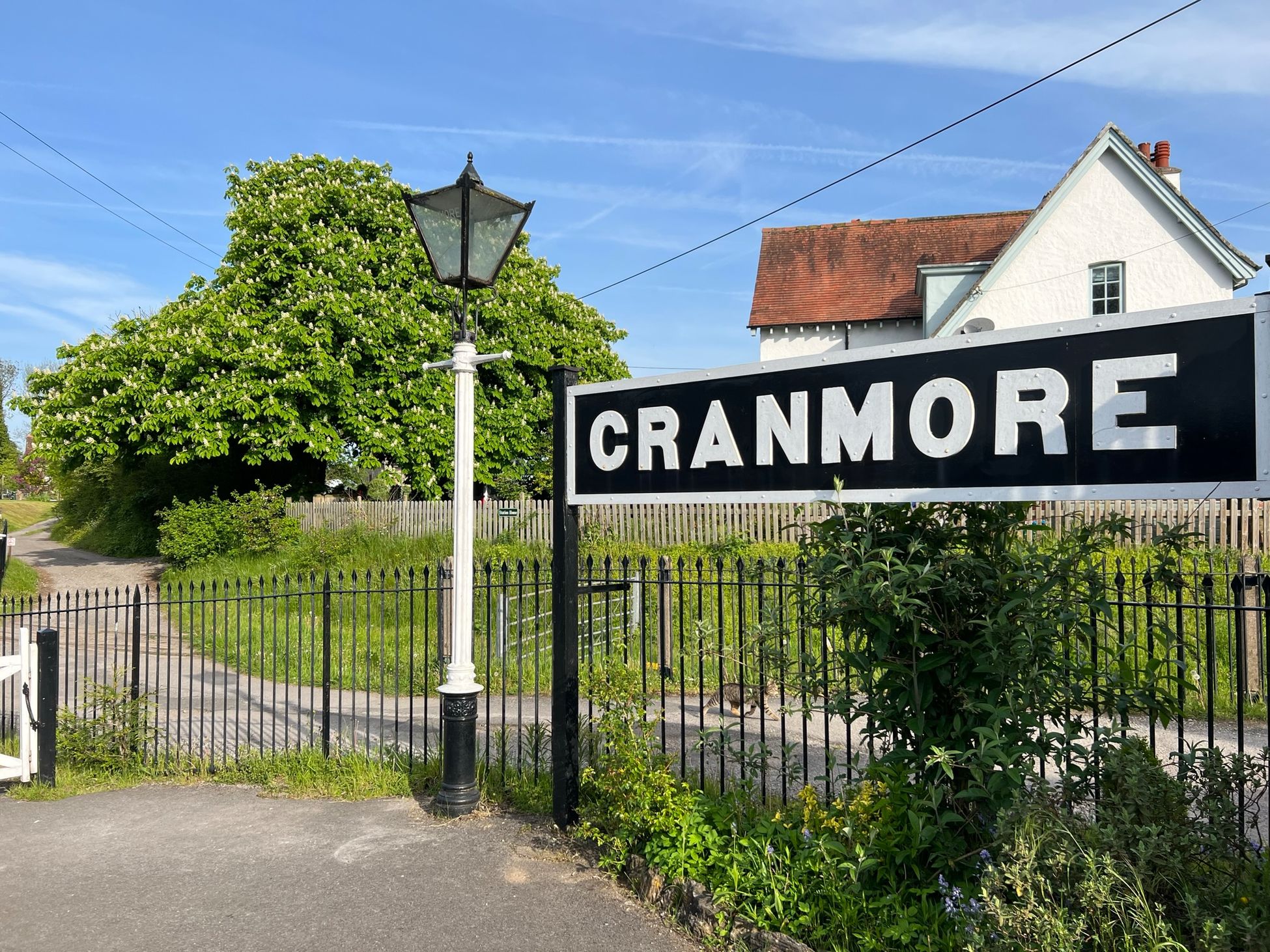 Sign at Cranmore Railway Station on a sunny day.